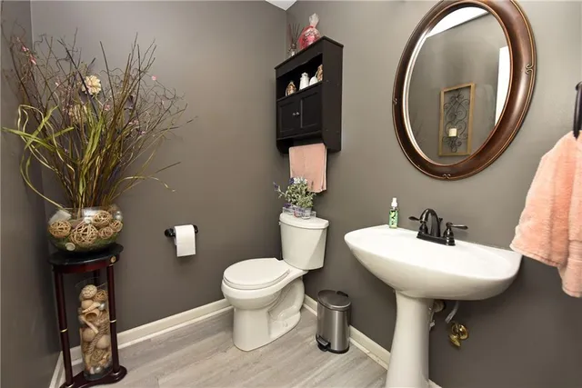 a bathroom with a sink toilet and a mirror