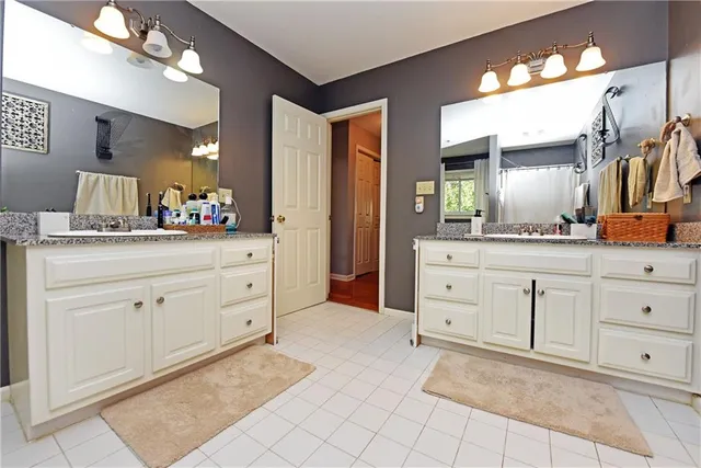 a spacious bathroom with a double vanity sink mirror and