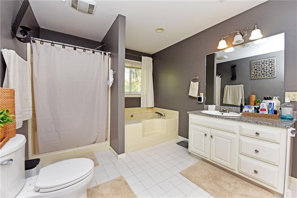 107 East Clinton Drive Southwest Rome, GA 30165 - Photo 24 of 38 a bath room with a toilet a sink and a large mirror