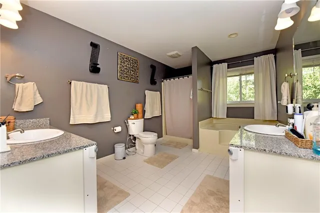 a bath room with sink and mirror