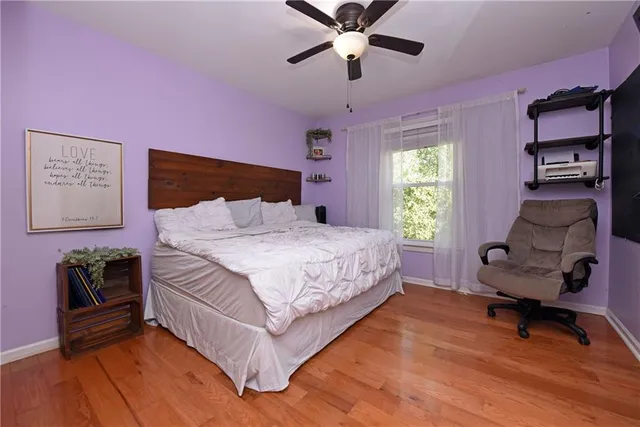 a bedroom with a bed and a chair