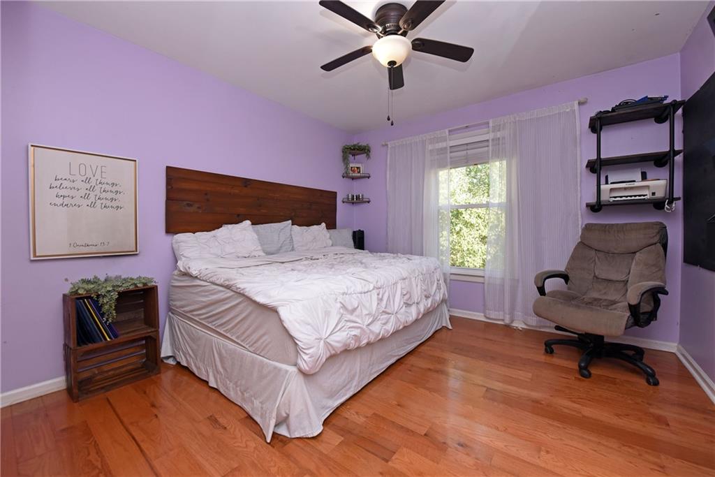 107 East Clinton Drive Southwest Rome, GA 30165 - Photo 26 of 38 a bedroom with a bed and a chair