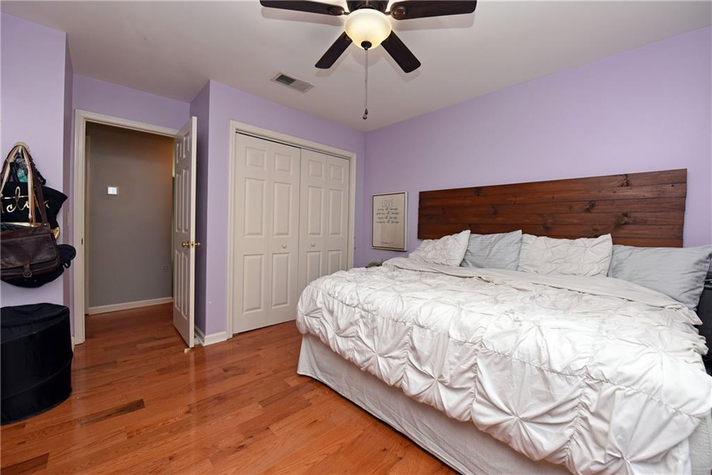 107 East Clinton Drive Southwest Rome, GA 30165 - Photo 27 of 38 a bedroom with a bed and a chandelier