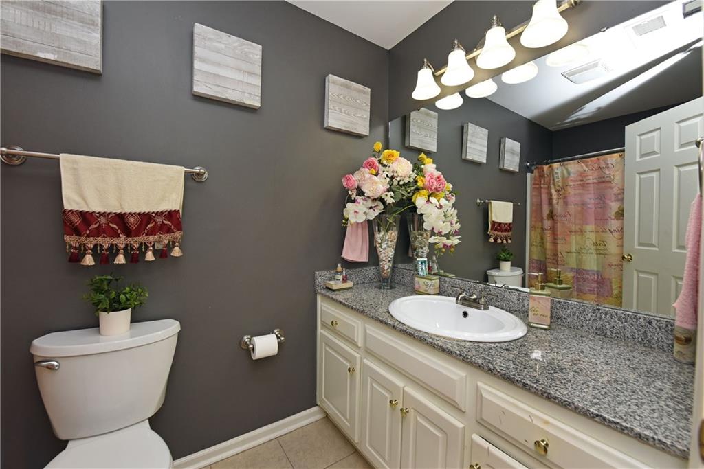 107 East Clinton Drive Southwest Rome, GA 30165 - Photo 28 of 38 a bathroom with a sink a toilet and a mirror