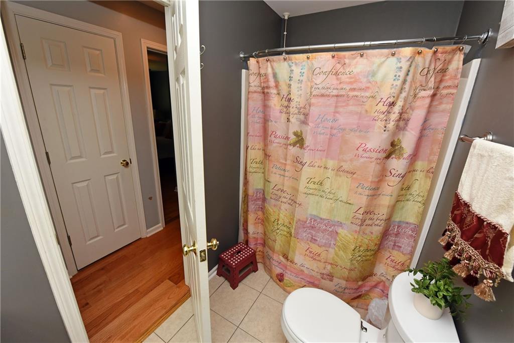 107 East Clinton Drive Southwest Rome, GA 30165 - Photo 36 of 38 a bathroom with a shower curtain and sink
