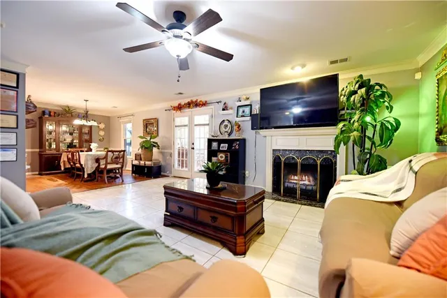 a living room with furniture a fireplace and a flat screen tv