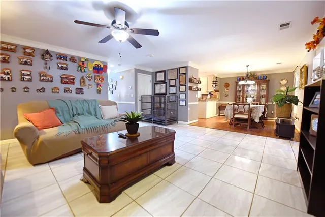 a living room with furniture and a chandelier