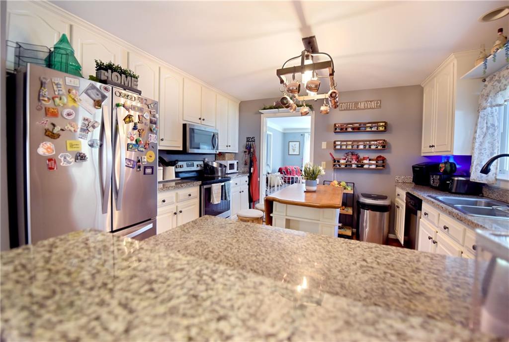 107 East Clinton Drive Southwest Rome, GA 30165 - Photo 9 of 38 a kitchen with stainless steel appliances granite countertop a refrigerator and a stove top oven