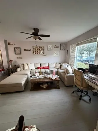 a living room with furniture and a large window