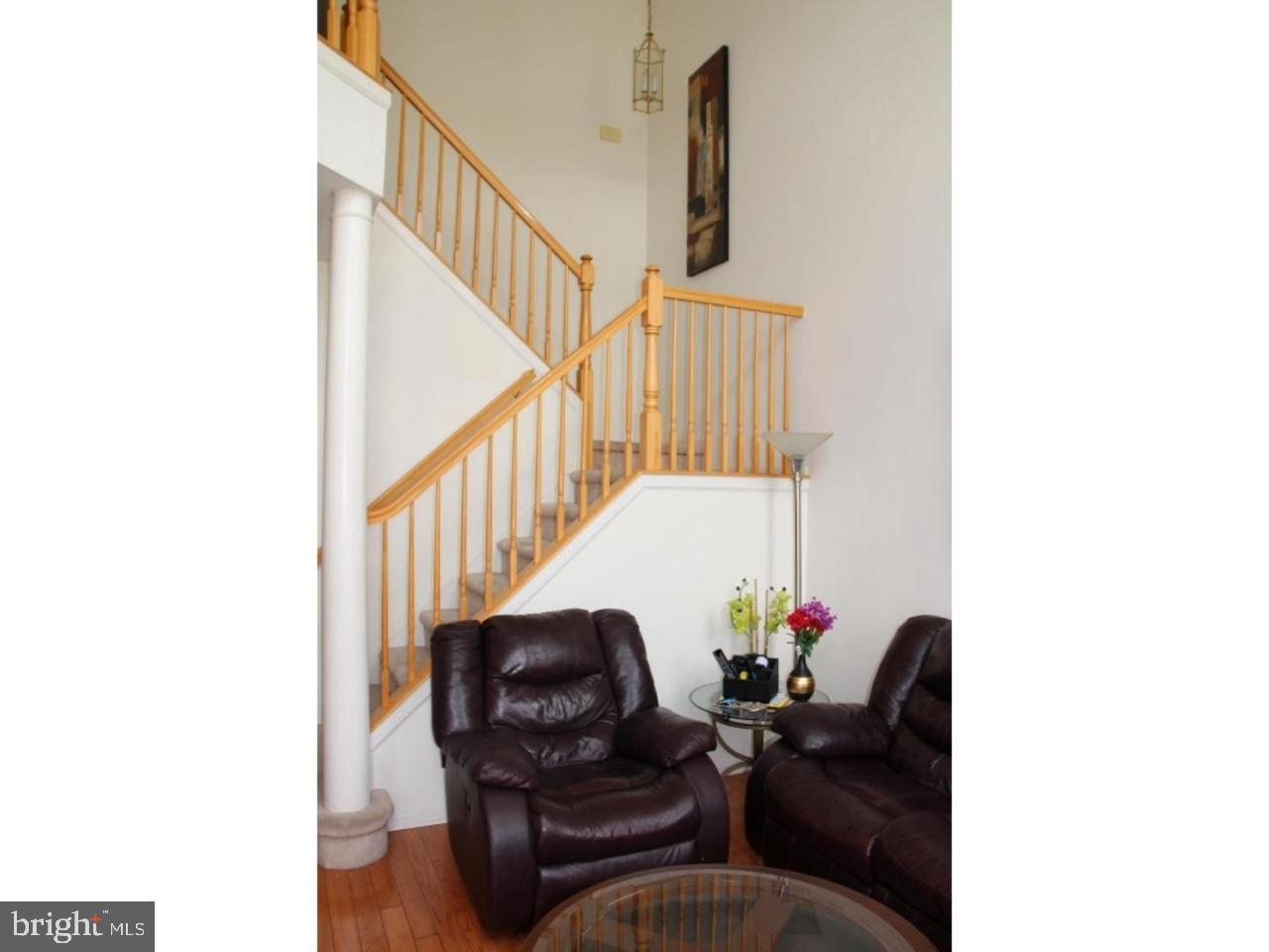 8 Stafford Drive Princeton Junction, NJ 08550 - Photo 5 of 7 a living room with furniture and a potted plant