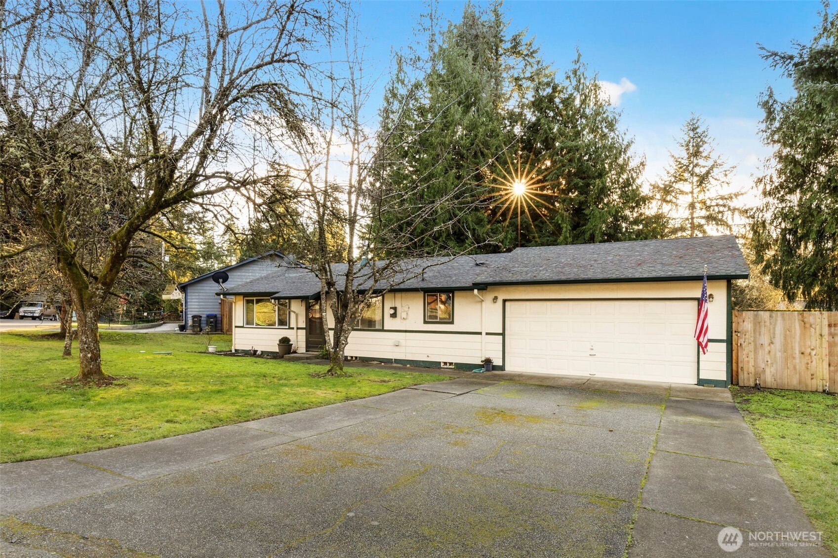 7606 Sandy Way Northeast Poulsbo, WA 98370 - Photo 2 of 20 a view of a house with a yard and garage