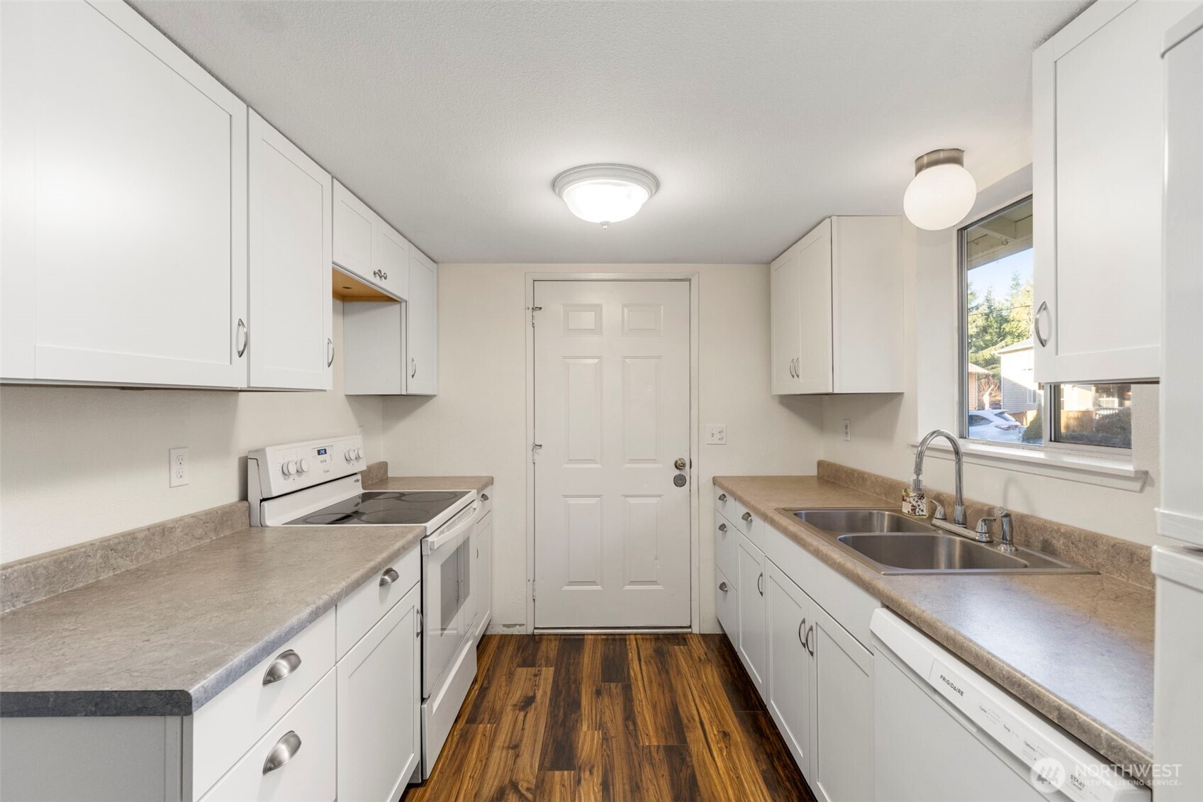 7606 Sandy Way Northeast Poulsbo, WA 98370 - Photo 6 of 20 a kitchen with a sink stove and cabinets