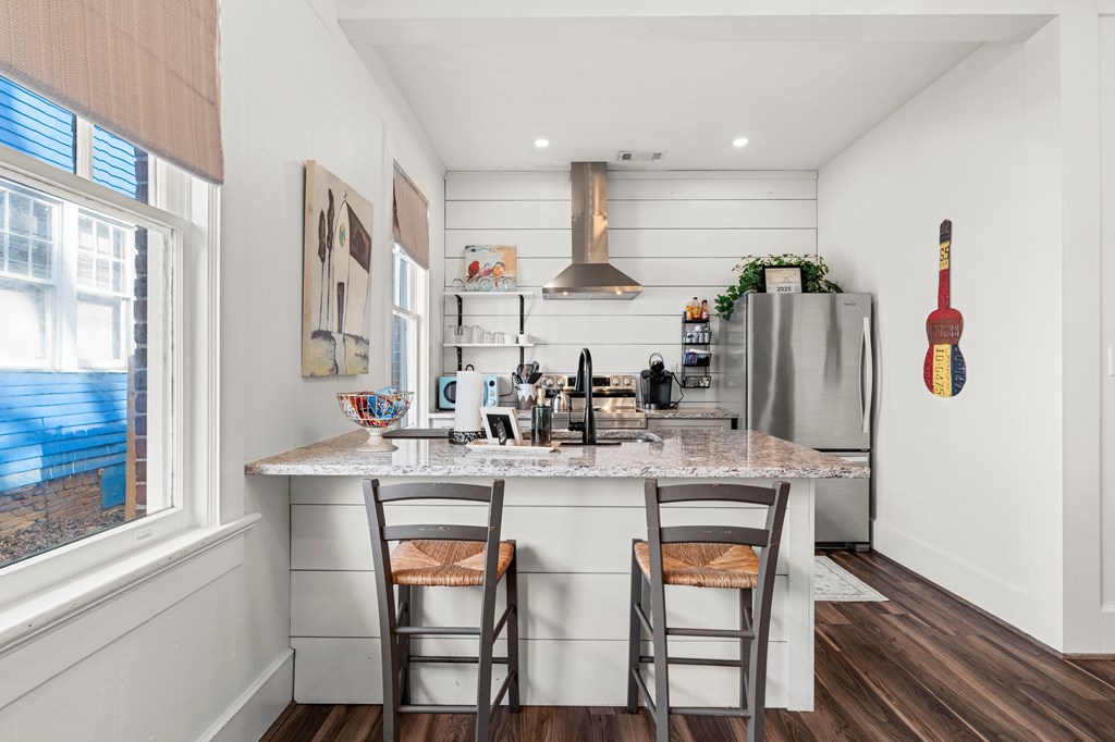 820 2nd Avenue Columbus, GA 31901 - Photo 11 of 28 a kitchen with stainless steel appliances granite countertop a table chairs stove and refrigerator