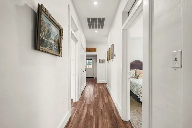 a bedroom with two beds and a potted plant