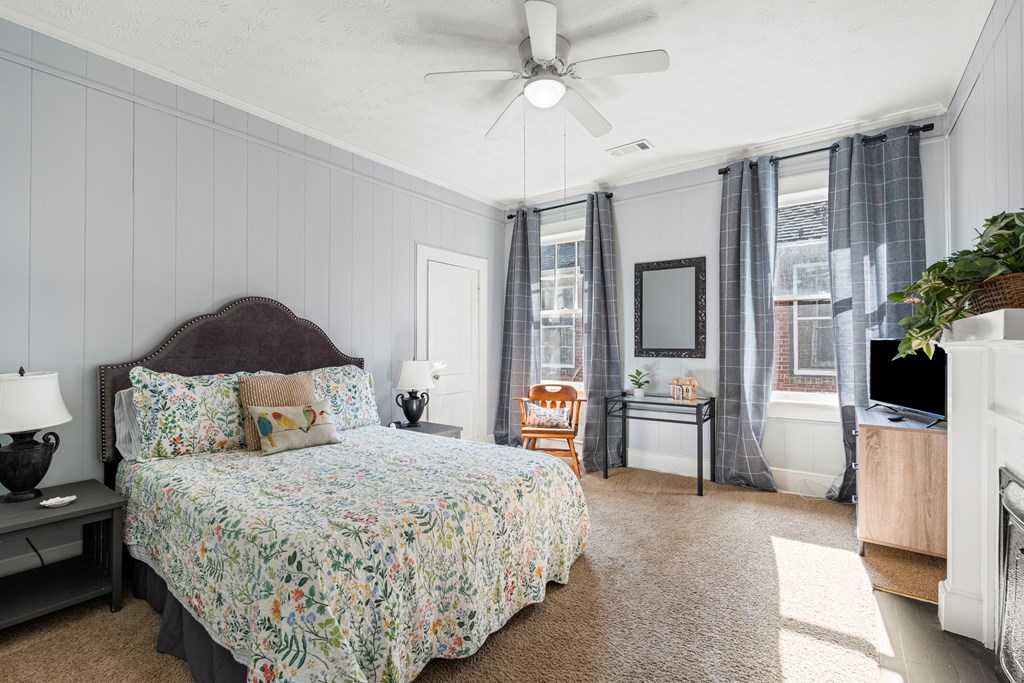 820 2nd Avenue Columbus, GA 31901 - Photo 18 of 28 a bedroom with a large bed and a chandelier