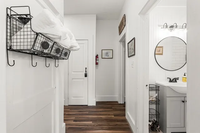a spacious bedroom with a bed a fireplace and a chandelier