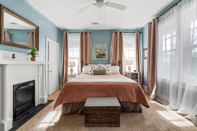 a bedroom with a bed and a fireplace