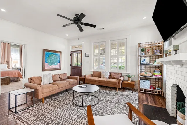 a living room with furniture fireplace and a flat screen tv
