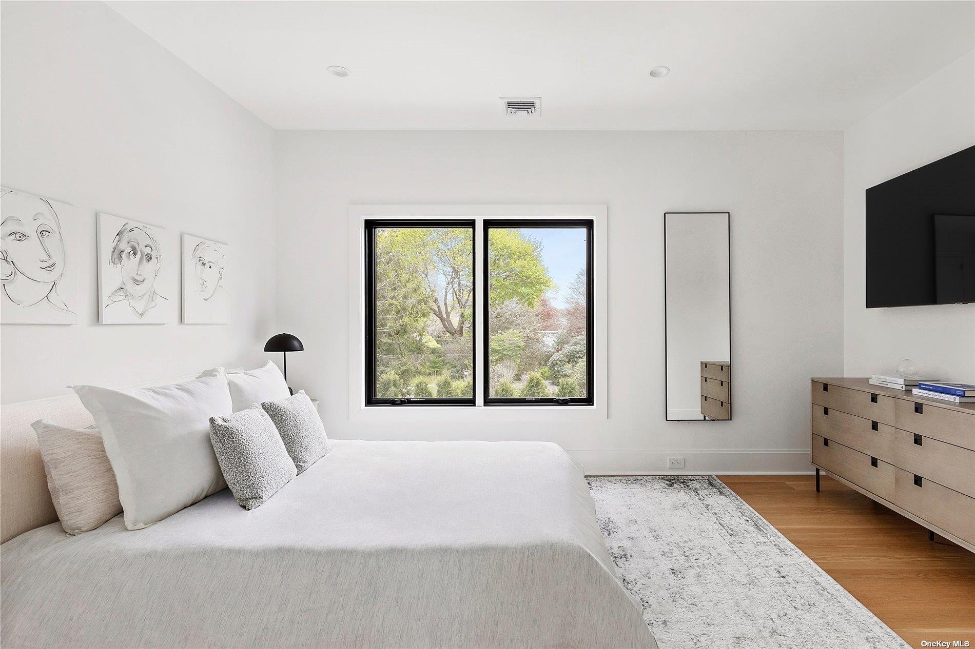 38 Sherrill Road East Hampton, NY 11937 - Photo 11 of 21 a bedroom with a bed and a flat screen television