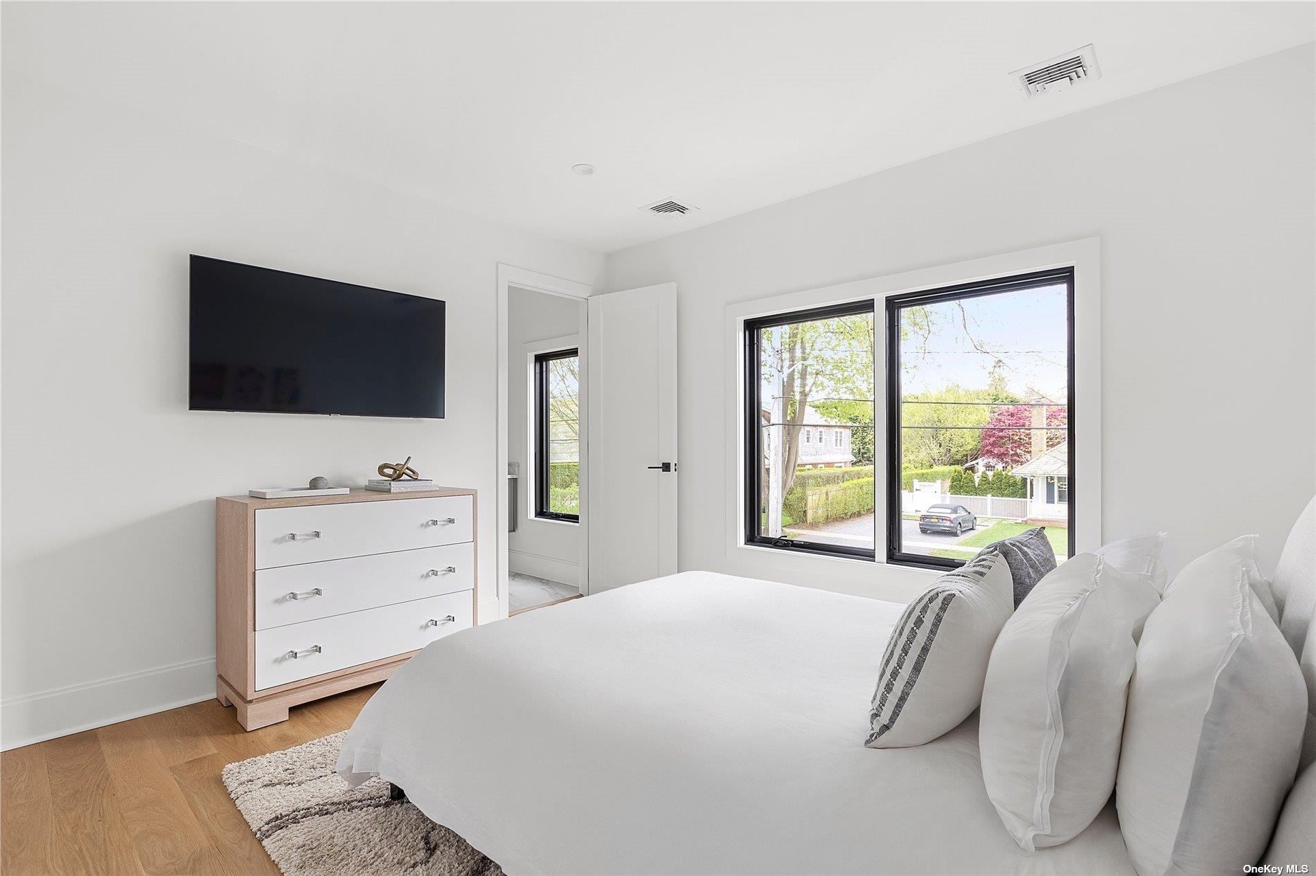 38 Sherrill Road East Hampton, NY 11937 - Photo 15 of 21 a bedroom with a bed and a flat screen tv