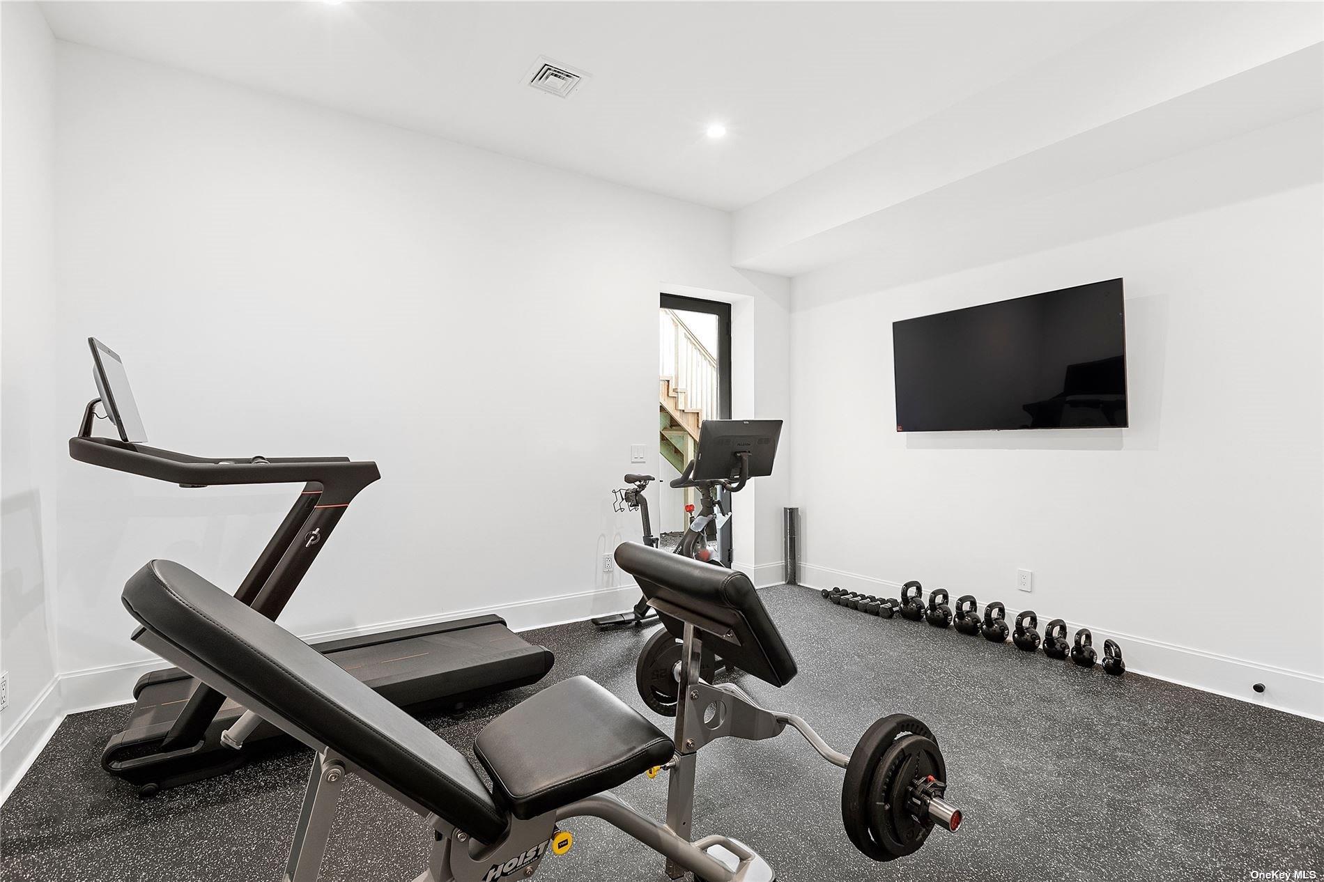38 Sherrill Road East Hampton, NY 11937 - Photo 19 of 21 a view of a workspace with furniture and a flat screen tv
