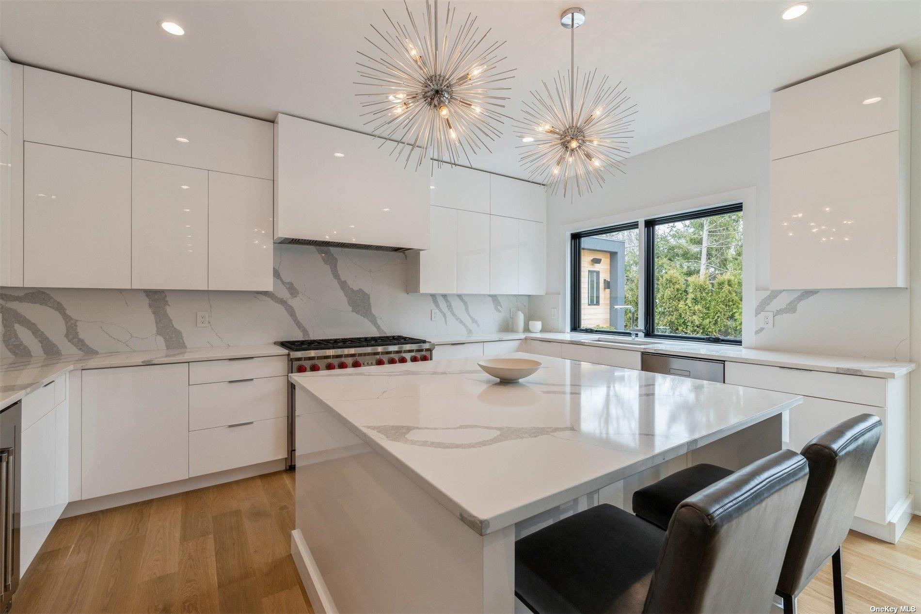 38 Sherrill Road East Hampton, NY 11937 - Photo 5 of 21 a kitchen with a stove a chandelier and a refrigerator