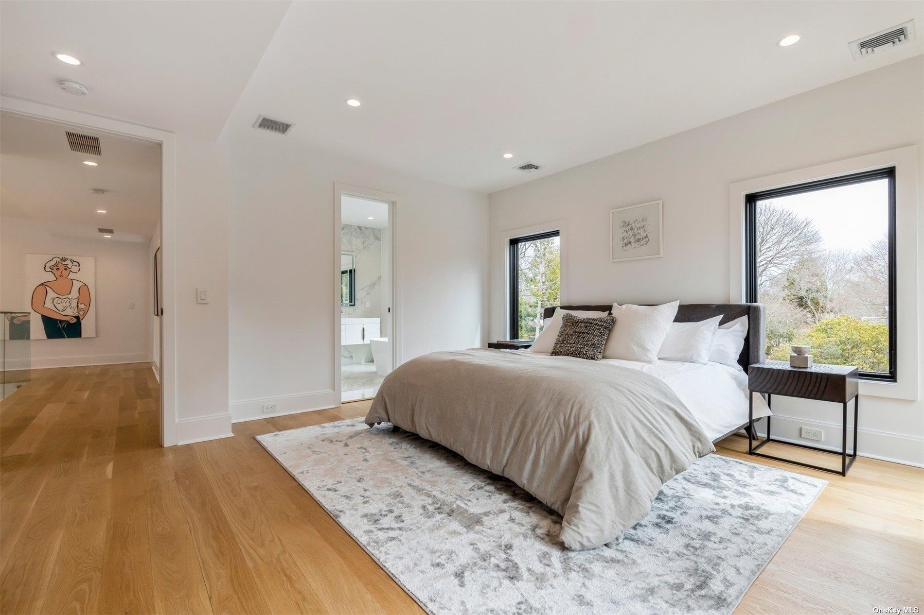 38 Sherrill Road East Hampton, NY 11937 - Photo 9 of 21 a spacious bedroom with a bed and large windows