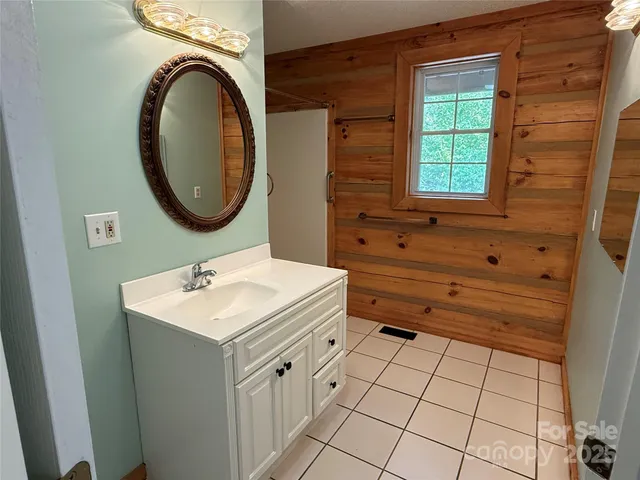 a bathroom with a shower and a mirror