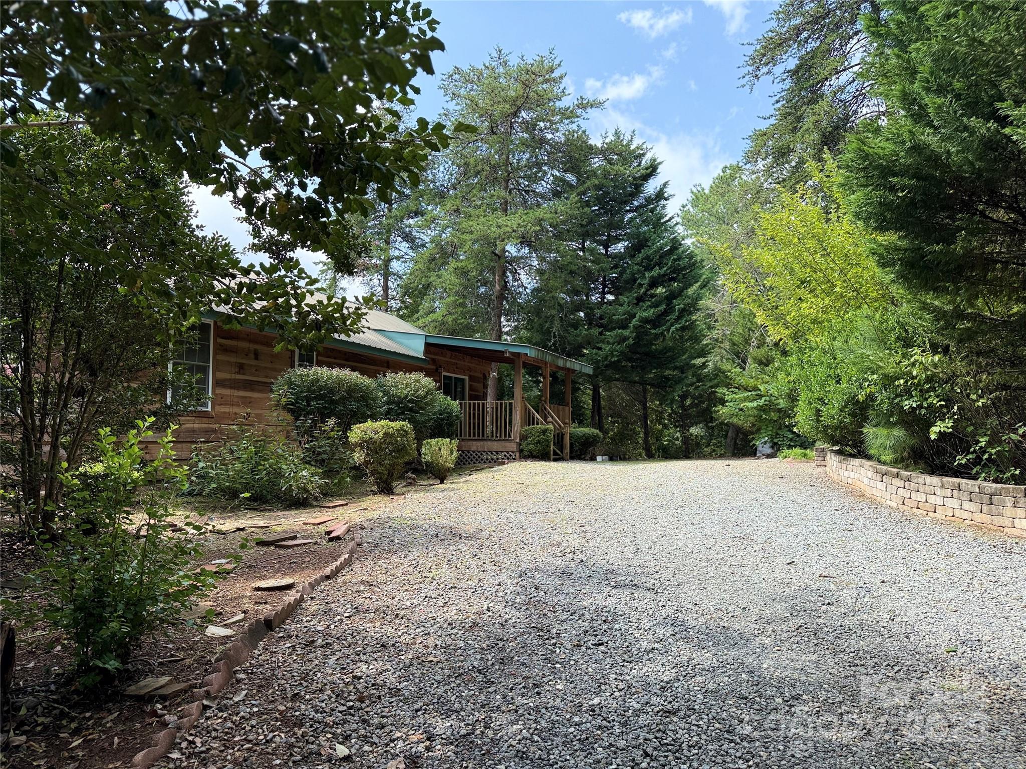 66 Ashlyn Lane Tryon, NC 28782 - Photo 7 of 40 a wooden bench with a tree in the background