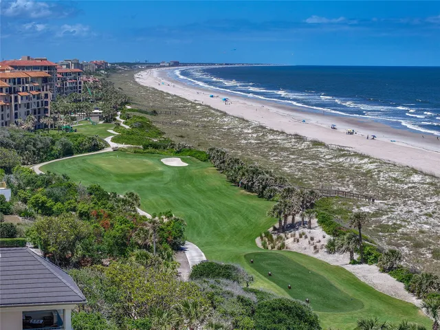 a living room with furniture fireplace and a large window