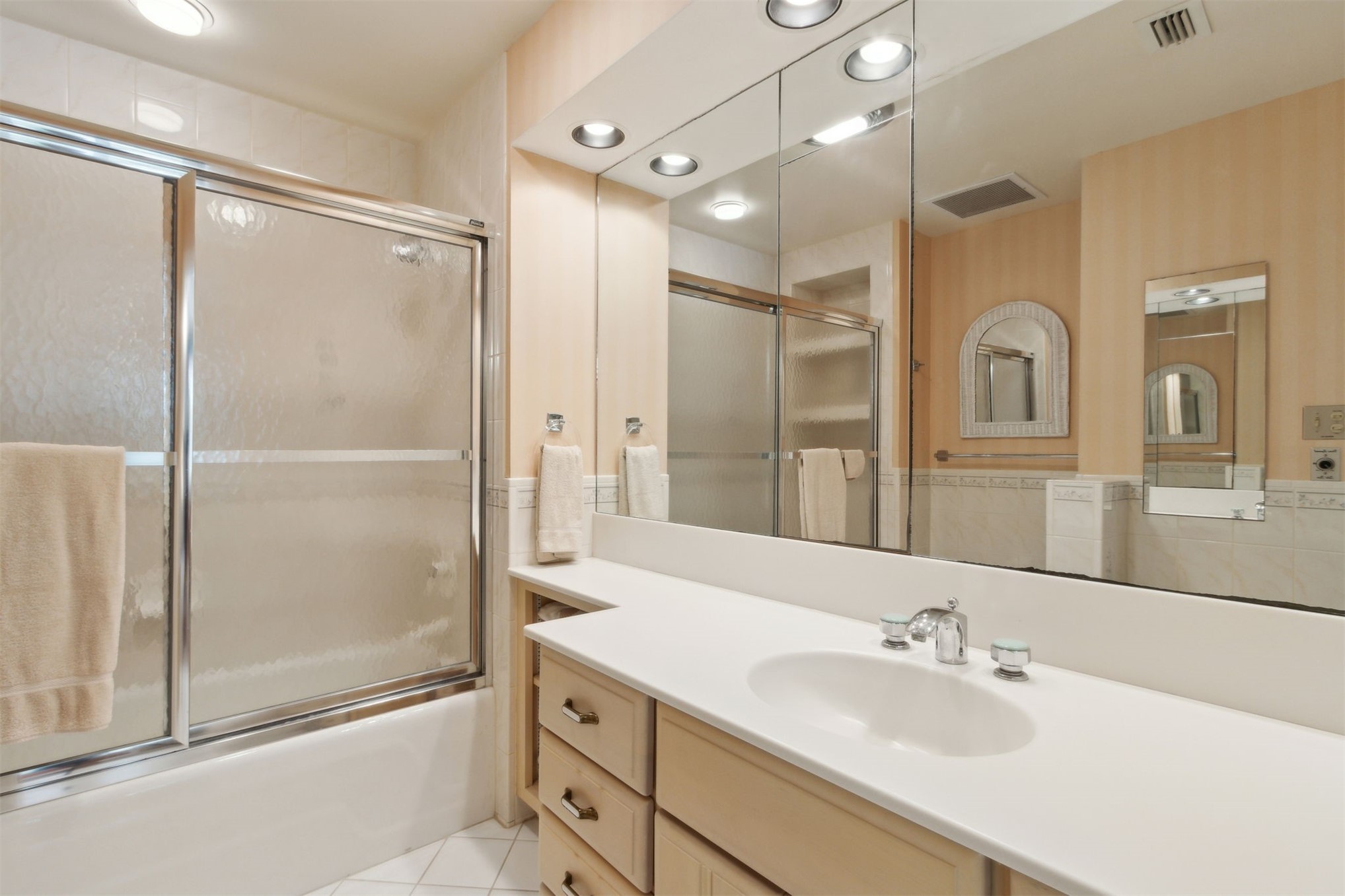 28 Dunes Row Fernandina Beach, FL 32034 - Photo 60 of 99 a bathroom with a shower sink vanity and mirror