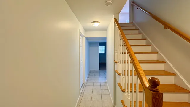 a view of a livingroom with an empty space and a window