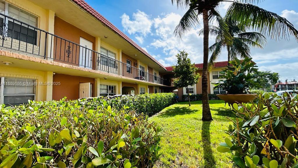 978 Southwest 10th Drive, Unit 9 Pompano Beach, FL 33060 - Photo 2 of 13 a view of a building with a garden