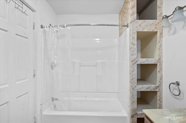 a bathroom with a shower and a tub