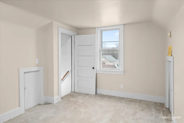 an empty room with windows and closet