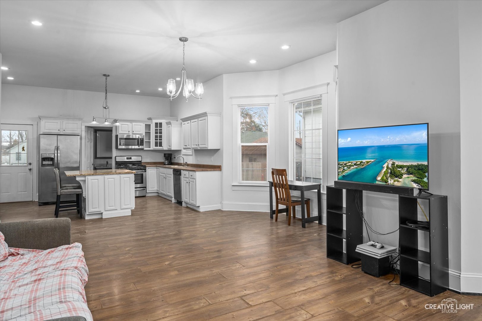 1409 Pulaski Street Peru, IL 61354 - Photo 2 of 20 a open kitchen with stainless steel appliances granite countertop a refrigerator dining table and chairs