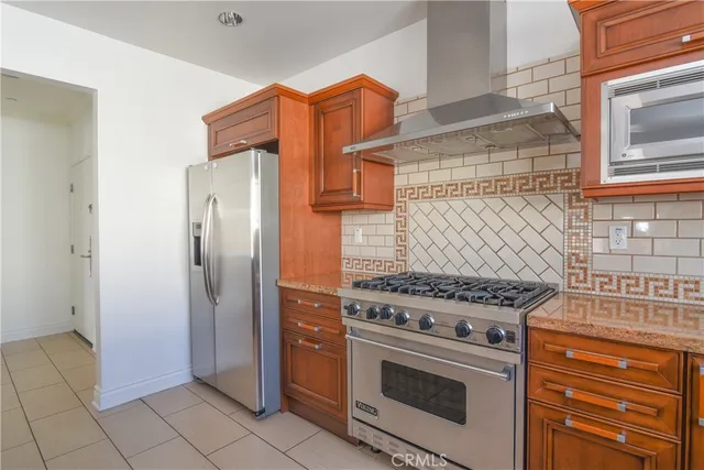 a kitchen with stainless steel appliances granite countertop a stove and a refrigerator