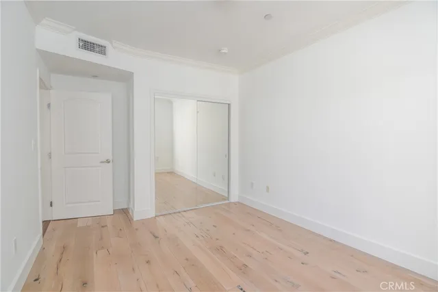 an empty room with wooden floor