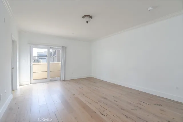a view of an empty room and wooden floor