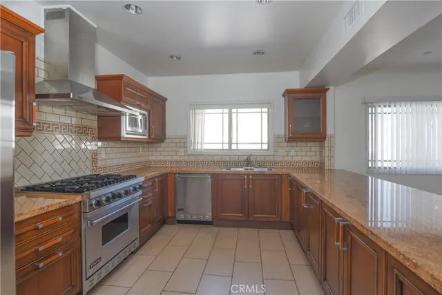 a kitchen with a stove top oven sink and cabinets