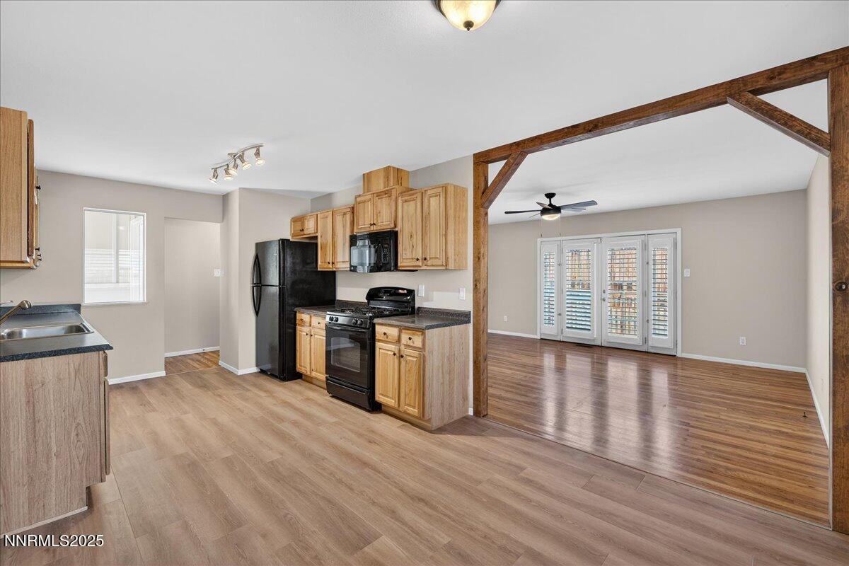 1495 Doric Drive Reno, NV 89503 - Photo 13 of 42 a view of kitchen with stainless steel appliances kitchen island wooden floors and refrigerator
