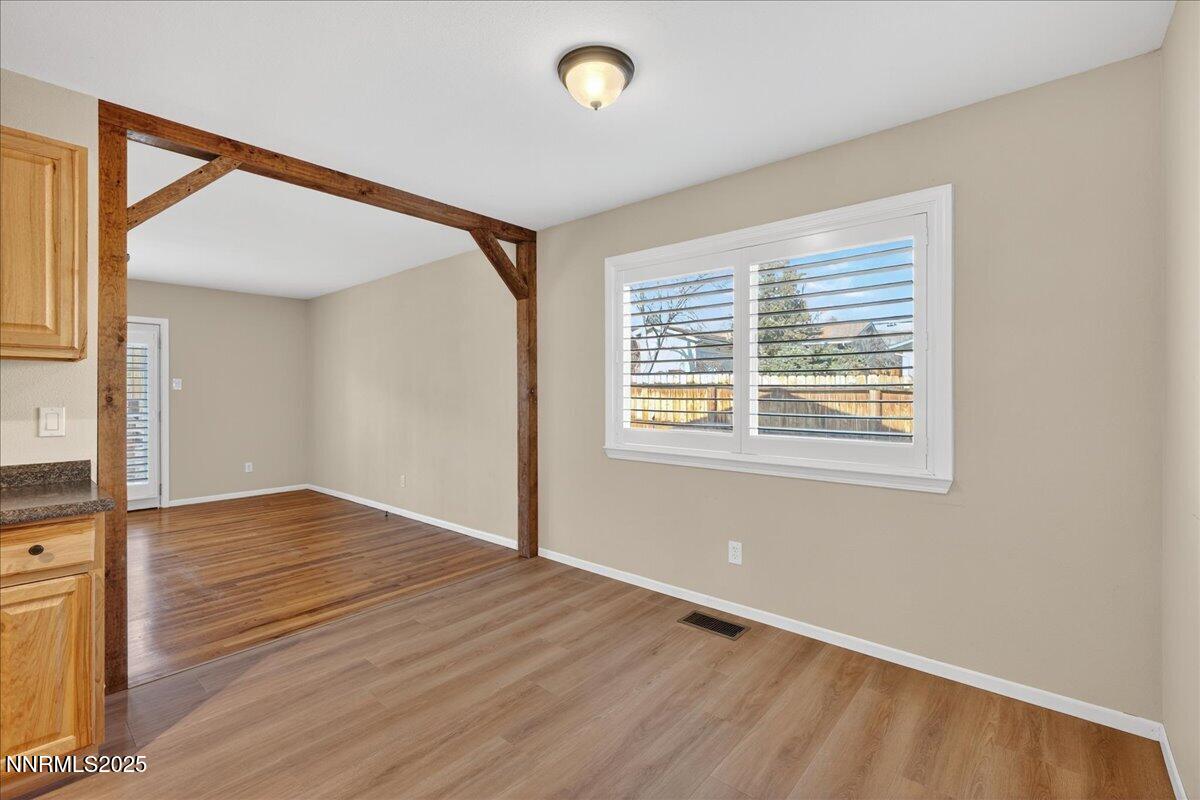 1495 Doric Drive Reno, NV 89503 - Photo 14 of 42 a view of an empty room with wooden floor and a window