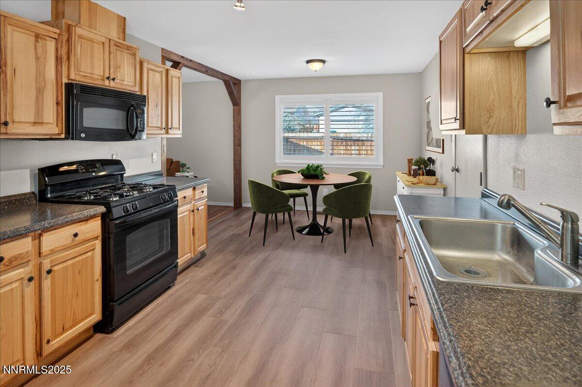 1495 Doric Drive Reno, NV 89503 - Photo 15 of 42 a kitchen with granite countertop a stove a sink a dining table and chairs