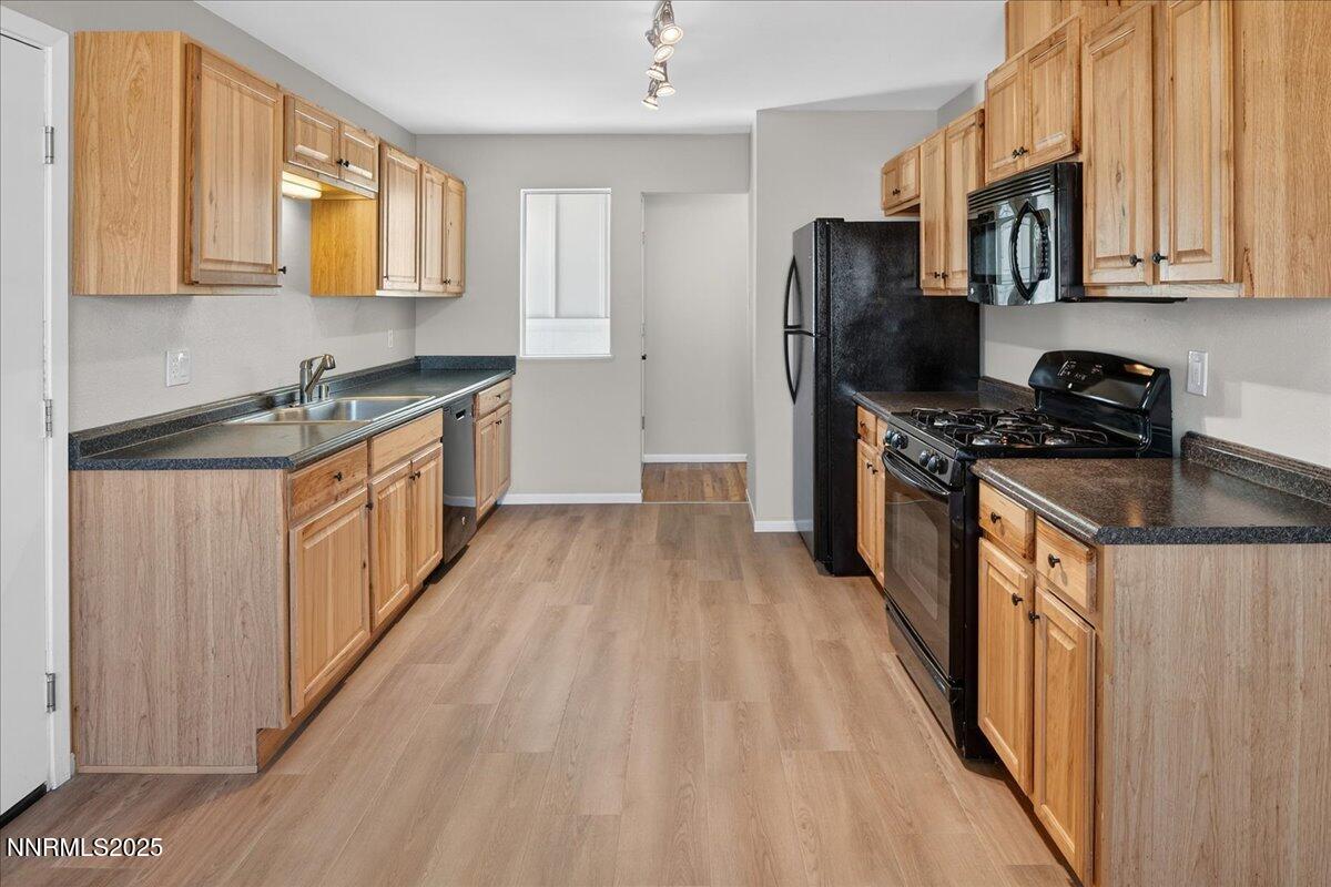 1495 Doric Drive Reno, NV 89503 - Photo 17 of 42 a kitchen with stainless steel appliances granite countertop a stove a sink dishwasher and a refrigerator
