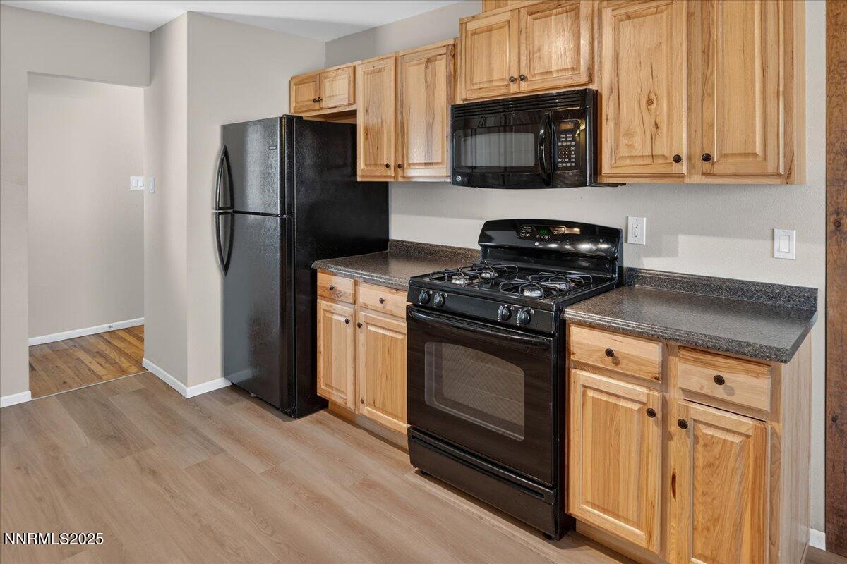 1495 Doric Drive Reno, NV 89503 - Photo 18 of 42 a kitchen with stainless steel appliances granite countertop a stove a refrigerator and a microwave