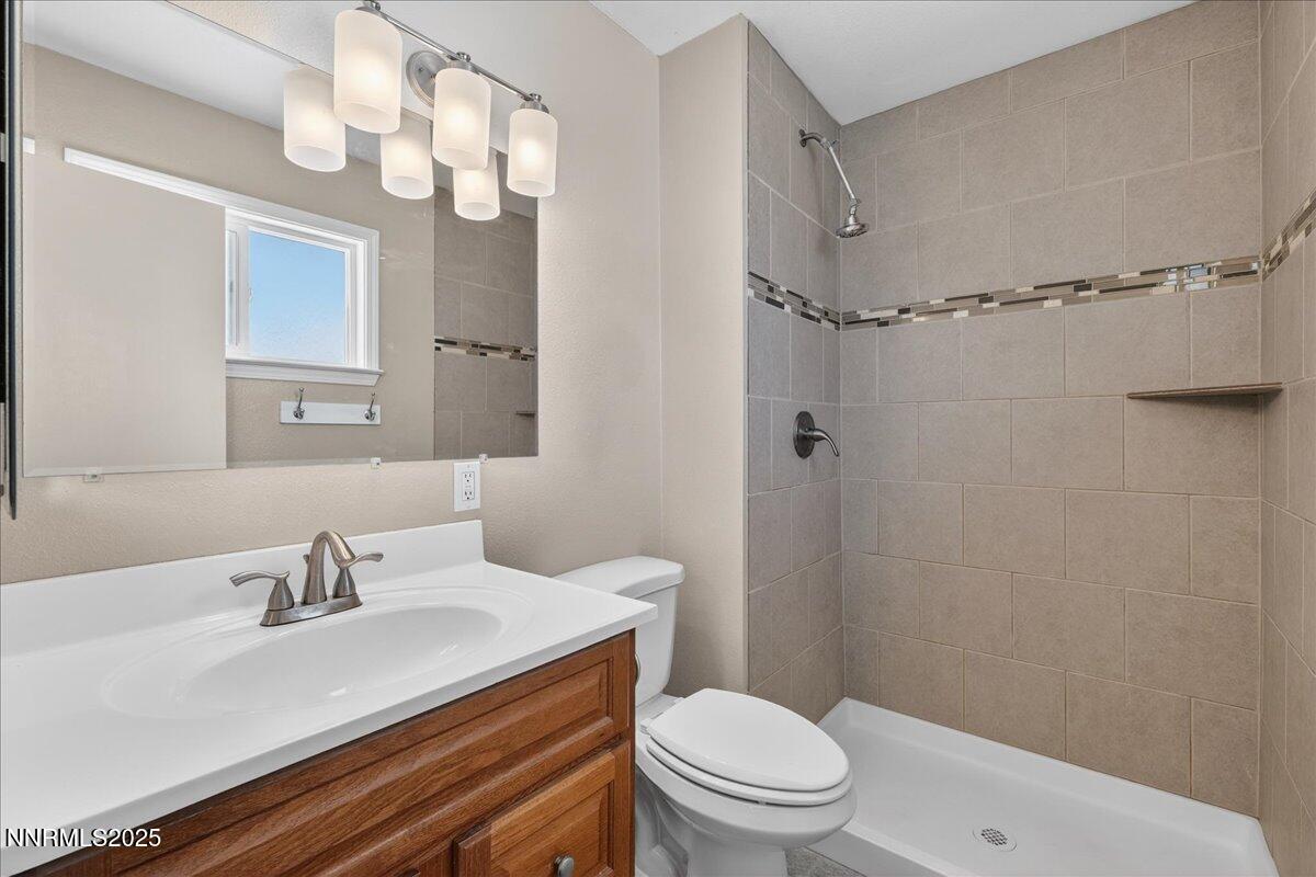 1495 Doric Drive Reno, NV 89503 - Photo 22 of 42 a bathroom with a sink a toilet a mirror and shower
