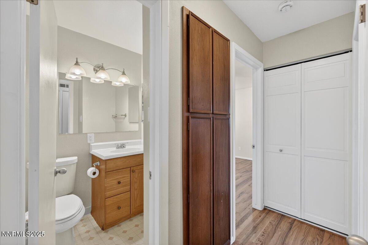 1495 Doric Drive Reno, NV 89503 - Photo 28 of 42 a bathroom with a toilet a sink and a mirror