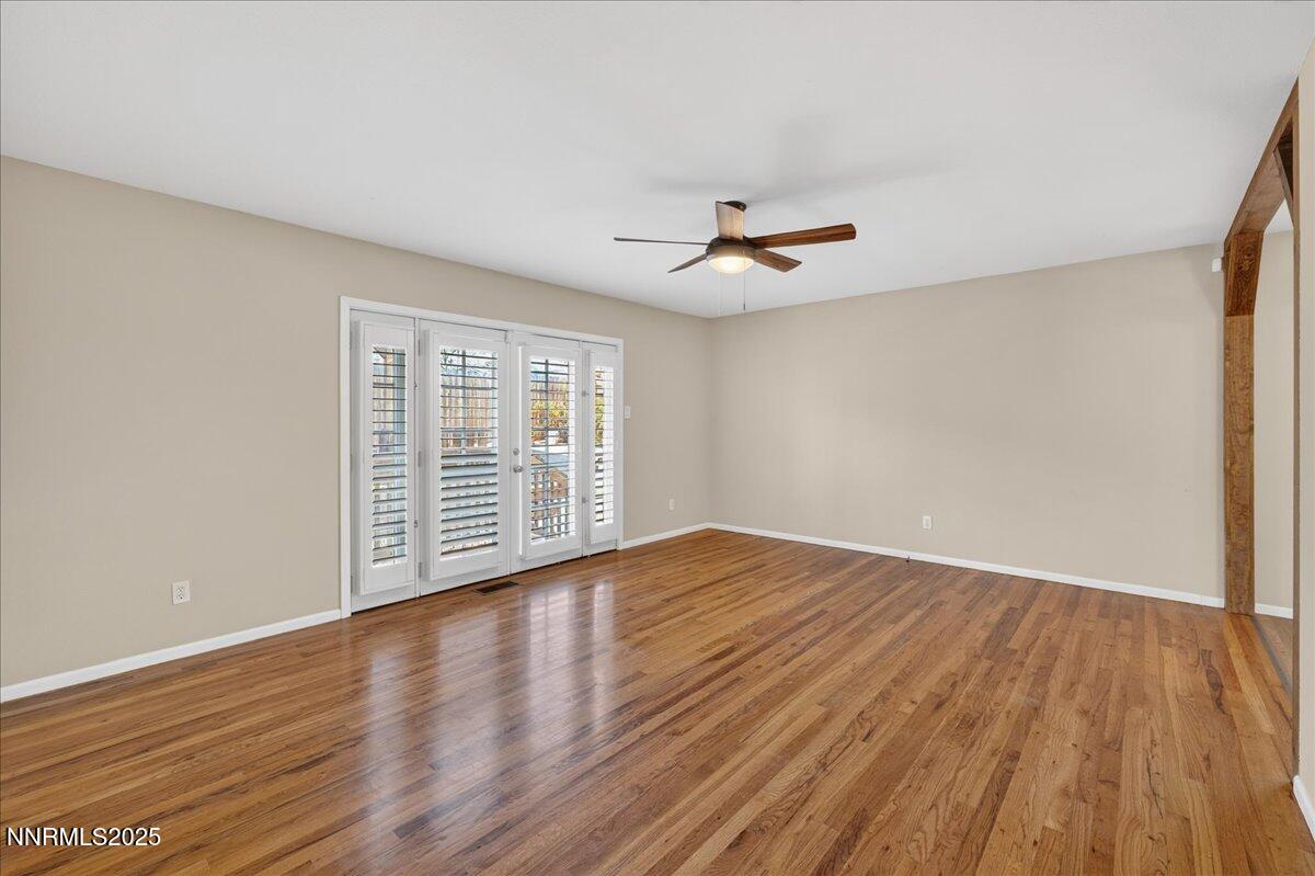 1495 Doric Drive Reno, NV 89503 - Photo 7 of 42 a view of an empty room with wooden floor and a window