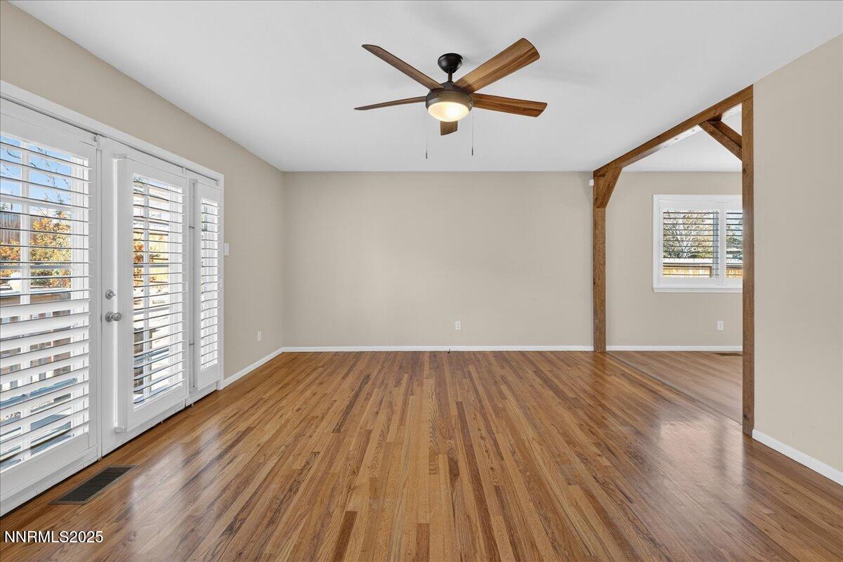1495 Doric Drive Reno, NV 89503 - Photo 8 of 42 an empty room with wooden floor and windows