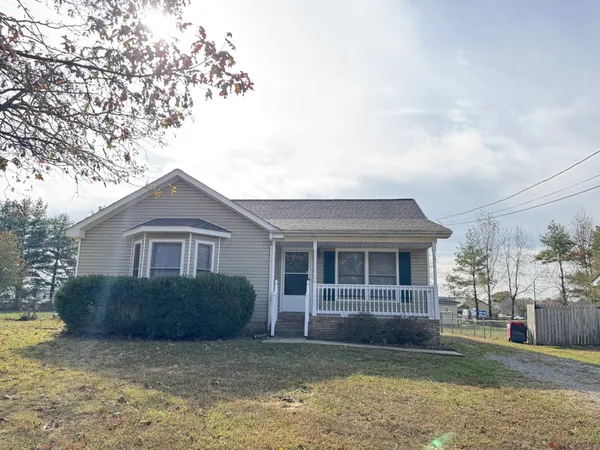 a front view of a house with a garden and yard